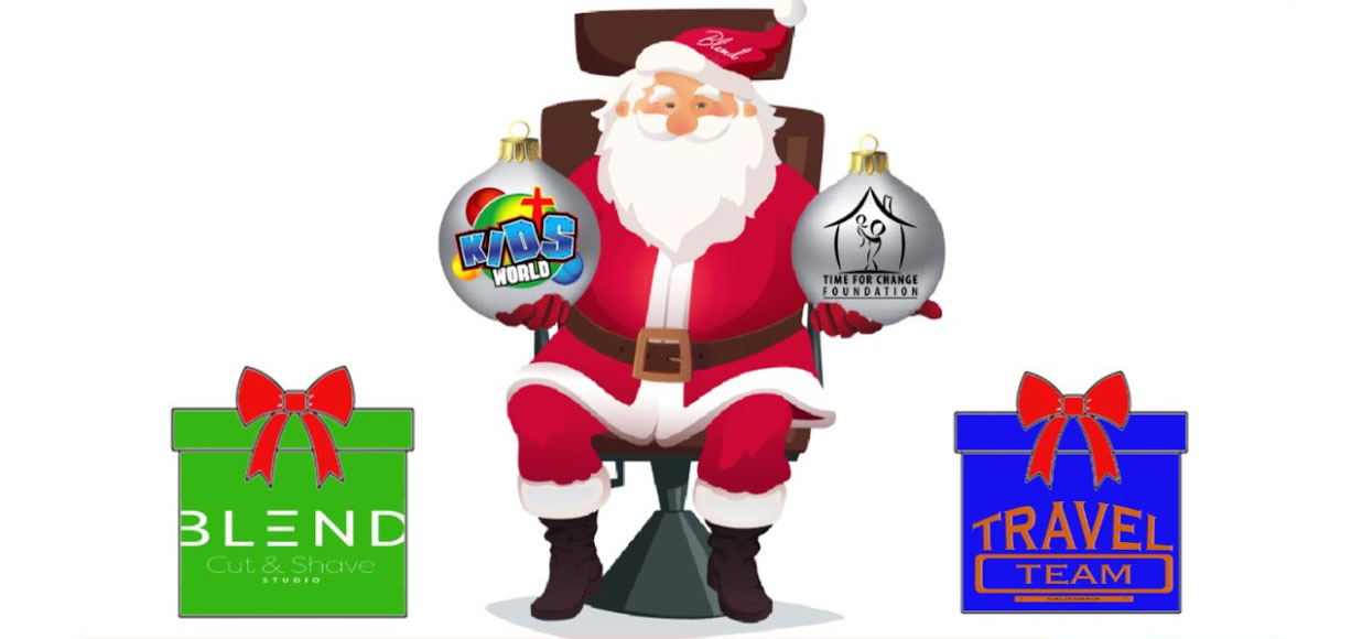 Santa Claus sits on a chair holding two ornaments labeled "Kids World" and "Time for Change Foundation," with gift boxes labeled "Blend Cut & Shave Studio" and "Travel Team" beside him.
