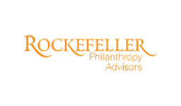 The image shows the Rockefeller Philanthropy Advisors logo with the name in orange text on a light background.